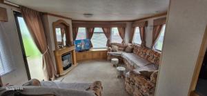 a living room with a couch and a tv at No 21 The Tummel in Forfar