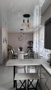 a dining room with chairs and a table and a dining room at Lake Relax in Chernihiv