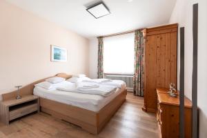 a bedroom with a bed and a large window at Beim Franz in Lermoos