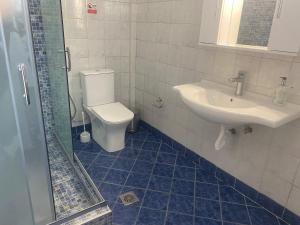 a bathroom with a toilet and a sink at Casa Koutrea in Kastanéa +14 photos