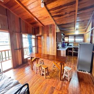 a kitchen with a wooden table in a room at Hostal Vista Verde in Mindo
