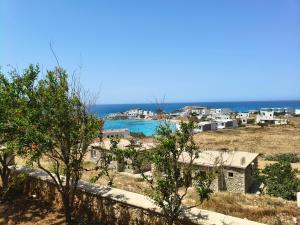 a view of a town with the ocean in the background at Gliko Onoiro in Lefkos Karpathou
