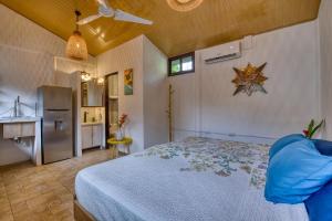 a bedroom with a bed and a kitchen at Beachfront Studio - King Bed - Fast WiFi - AC in Cocles