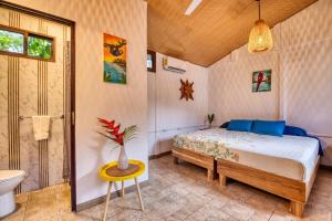 a bedroom with a bed and a toilet and a sink at Beachfront Studio - King Bed - Fast WiFi - AC in Cocles