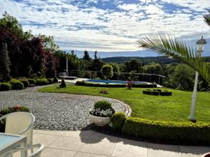 a garden with a stone walkway and a lawn with bushes at Ihre Auszeit am Golfplatz in Meisdorf +59 photos