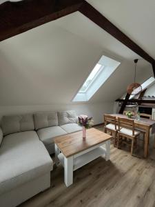 a living room with a couch and a table at Haus Wally - Ferienwohnungen in Klitten +16 photos