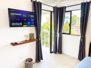a room with a large window with black curtains at TAYGA STUDIOS Cancun in Cancún