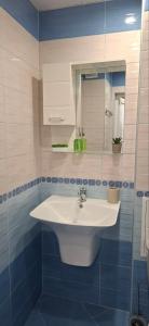 a bathroom with a white sink and a mirror at Harmonia in Ruse