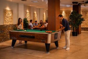 a man standing in front of a pool table at Hotel la Palmera & Spa in Lloret de Mar