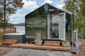 a glass igloo house with plants on a wooden deck at Lunar igloos - Kaamos in Karkku +5 photos