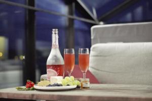 two glasses of wine and cheese on a table at Lunar igloos - Kaamos in Karkku