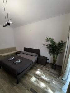 a bedroom with a bed and a potted plant at Oasi urbana in Turin