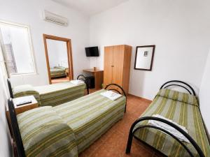 a hotel room with two beds and a mirror at Camera Cafè Affitta camere in Nardò