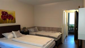 a bedroom with two beds and a window at Hotel Restaurant Rodetal in Nörten-Hardenberg