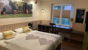 a bedroom with a bed with two hearts on it at Hotel Restaurant Rodetal in Nörten-Hardenberg