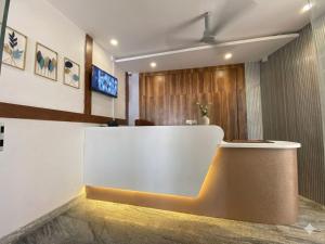 a lobby with a reception desk in a building at hotel ak grand in Mangalore