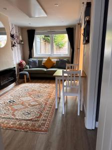 a living room with a couch and a table at The Lazy Fox, Shrewsbury in Shrewsbury