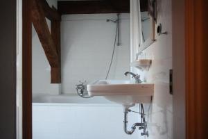 a bathroom with a sink and a bath tub at Ferienwohnung Herrenhaus Linker Seitenflügel II - Boldevitzer Rügenkaten in Parchtitz