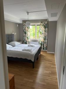 a bedroom with a bed and a window at Trollebo Säteri in Vetlanda
