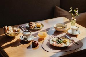 a table topped with plates of food and cups of coffee at Antholzer Wildsee Haus in San Giuseppe in Anterselva