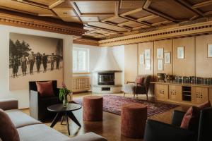 a living room with a couch and a fireplace at Antholzer Wildsee Haus in San Giuseppe in Anterselva +36 photos