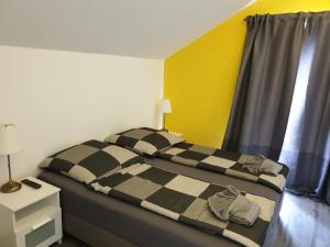 a bedroom with a bed with a checkered blanket at Haus Strandoase Nr 4 in Oldenburg in Holstein