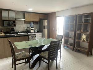 a kitchen with a table and chairs in a kitchen at Casa in Petrolina