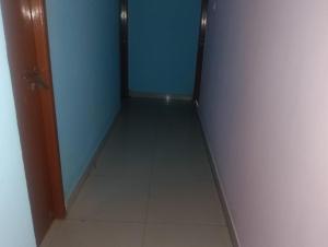 a hallway with a door and a tile floor at coastal charm in Chennai