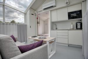 a living room with a table and a kitchen at Lunar Igloos - Lumi in Karkku