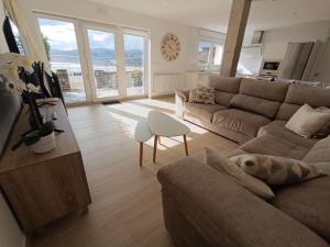 a living room with a couch and a table at Casa del Muelle COMILLAS in Comillas