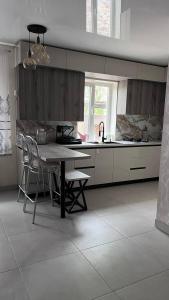 a kitchen with a table and chairs in it at Lake Relax in Chernihiv