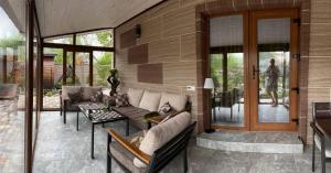 a living room with a couch and chairs and a table at Lake Relax in Chernihiv