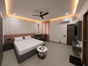 a bedroom with a bed and a flat screen tv at Hotel Golden Plaza in Amritsar +6 photos