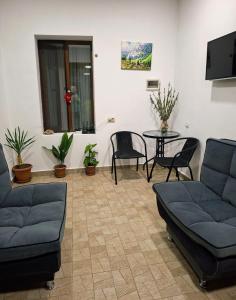 a living room with a couch and a table and chairs at Guest House Nanu in Mestia +12 photos