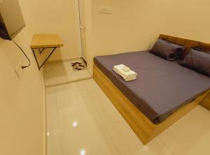 a small bedroom with a bed with a wooden frame at Hotel Mahakal Ujjain Prime in Ujjain +21 photos