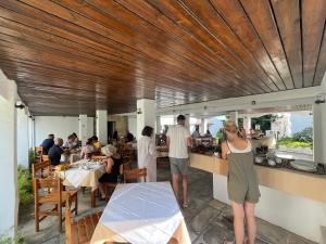 a restaurant with people ordering food at a counter at Hotel Maro in Agios Ioannis Pelio