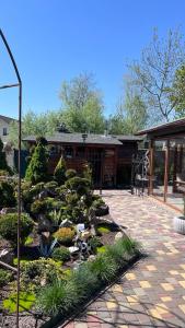 a garden with rocks and plants in front of a building at Lake Relax in Chernihiv +8 photos