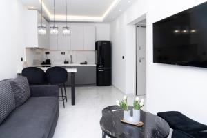a living room with a couch and a table at Agias Sofias Luxury Apartments in Thessaloniki