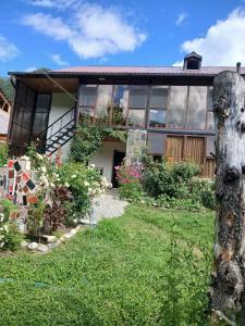 a house with a garden in front of it at Guest House Nanu in Mestia