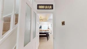 a hallway with a table and a sign on the wall at Sheringham Luxury, Cinema, Hot Tub & Beach in Sheringham