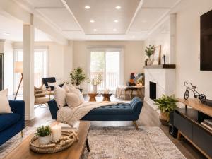 a living room with blue furniture and a fireplace at Lux 5BR Spacious Home Near Yonge St in Newmarket