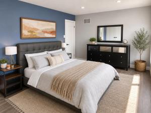 a bedroom with a large bed and a mirror at Lux 5BR Spacious Home Near Yonge St in Newmarket