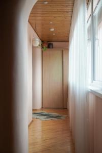 a hallway with a wooden ceiling and a window at Nida Center Studio Apartment in Neringa