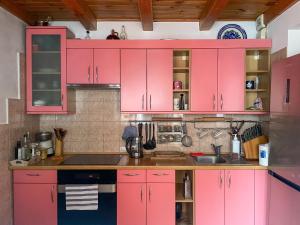 a kitchen with pink cabinets and a sink at Nida Center Studio Apartment in Neringa