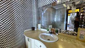 a bathroom with a sink and a mirror at Melilla Gate House in Nador +6 photos