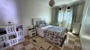 a bedroom with a bed and some windows at Melilla Gate House in Nador