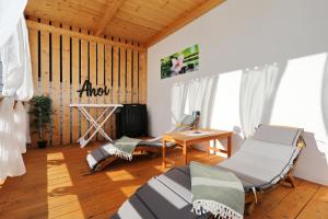 a room with two beds and a table and a desk at Strandhaus Ahoi 17, Terrasse mit Meerblick, Privatstrand, 2 Badezimmer in Drage