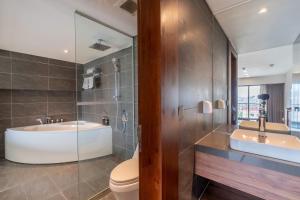 a bathroom with a tub and a toilet and a sink at Luxury Duplex & Apartment Pentstudio - Tay Ho Hanoi in Hanoi +43 photos