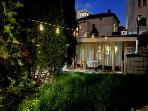 a house with a string of lights in the yard at Villa Re3ca in Skopje