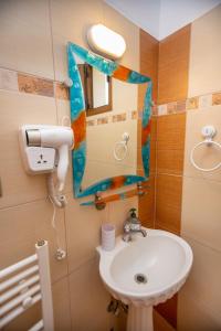 a bathroom with a sink and a mirror at Azura Studios in Stavros